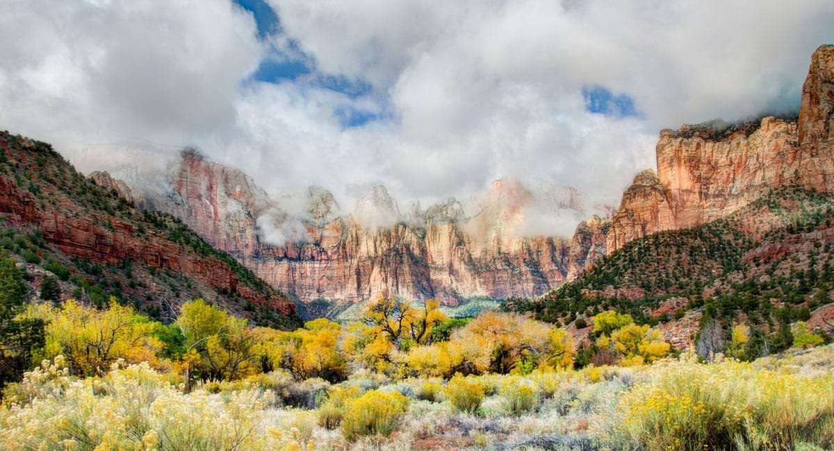 mist shrouds the tops of the peaks of Zion National Park