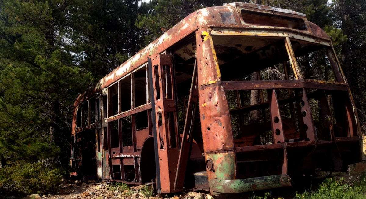 An abandoned bus picked apart from years of necessity.