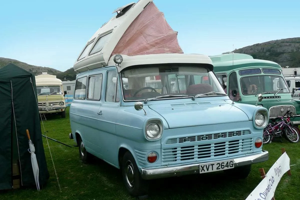 a baby blue old ford van with a poptop roof, a true classic