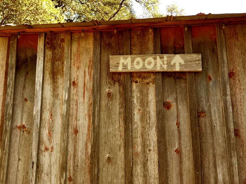 a sign that reads moon and points up