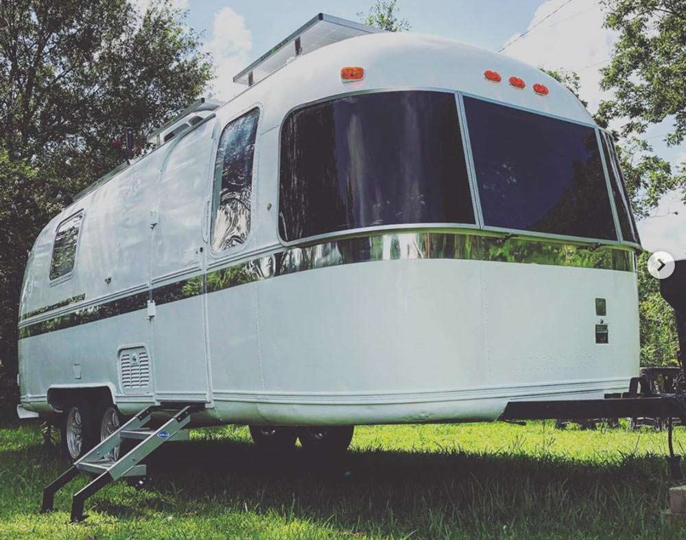 an Airstream Argosy, a white travel trailer with the classic Airstream shape