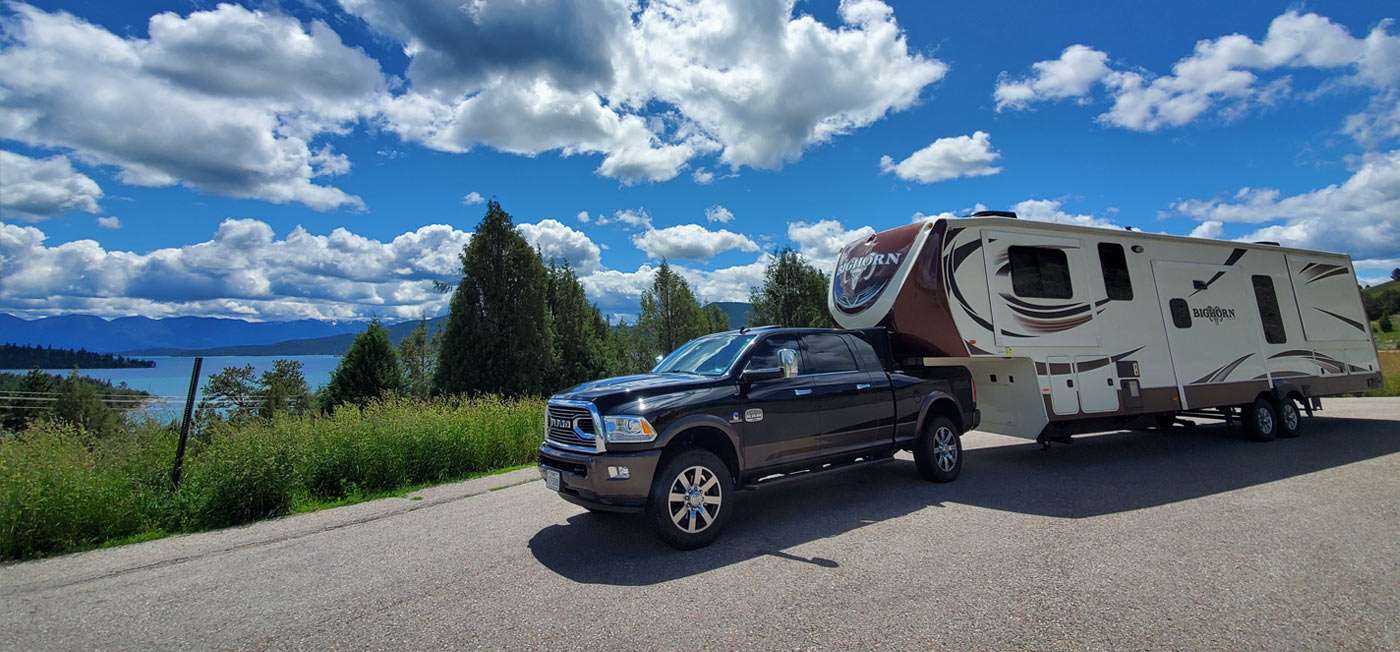 a large truck pulls an even larger RV!