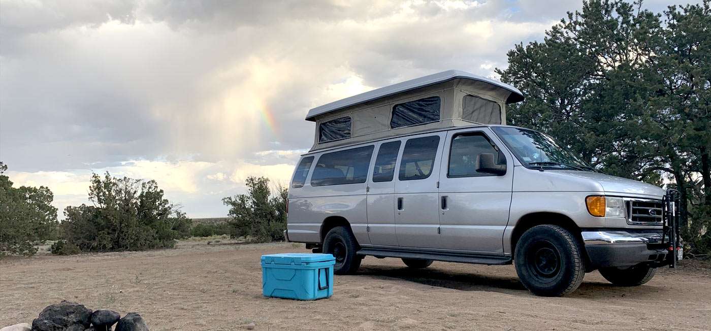 a Ford van soaking up the sun in a New Mexican desert