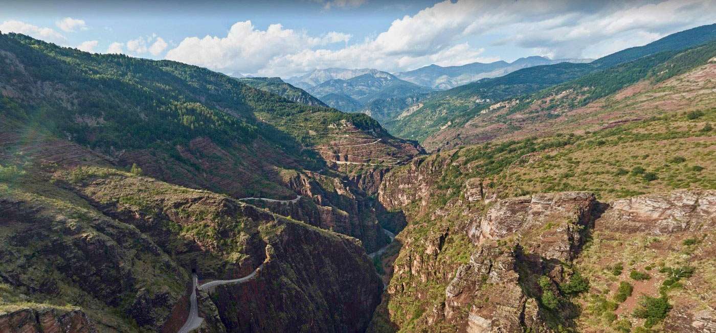a majestic canyon, river and road stretching through nature's grandeur