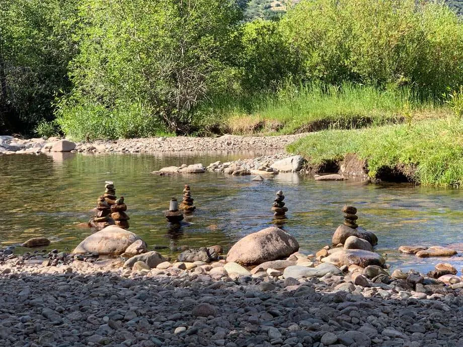 cairns stacked in a shallow creek