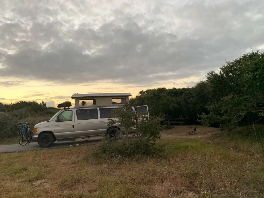 a van with its top popped camps at Frisco Campground