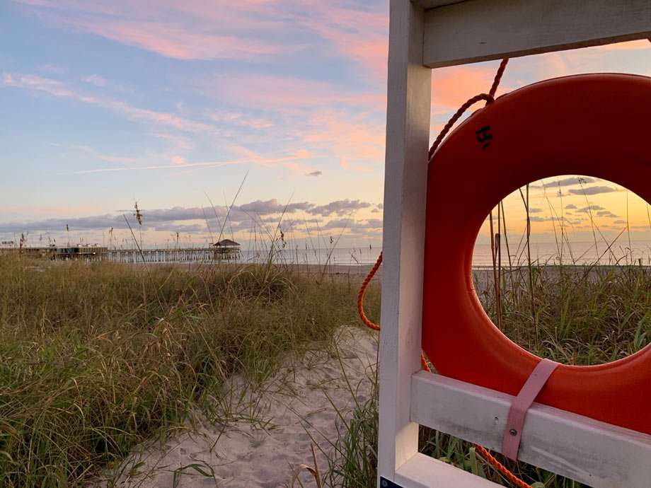 a life preserver, purple sunrise and the cocoa beach pier