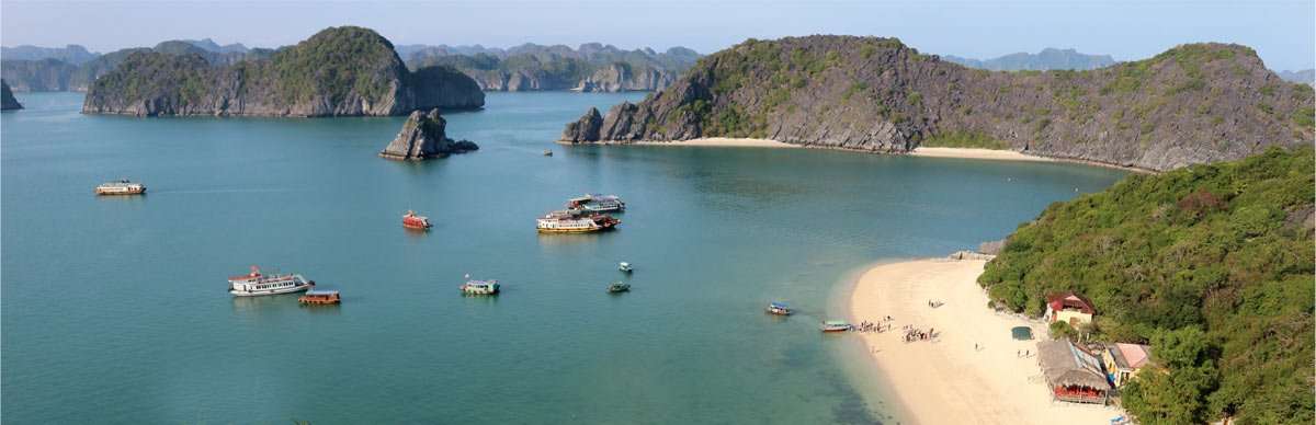 a small village and many boats in the plethora of island near cat ba island, vietnam