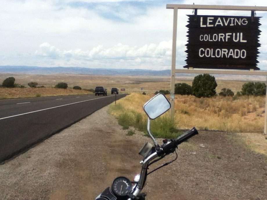 a sign reads Leaving Colorful Colorado