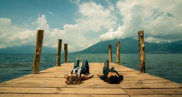 two women resting on a dock