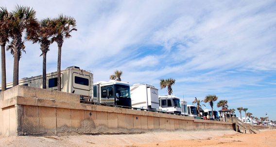 RVs lined up in a row against a beach in Florida