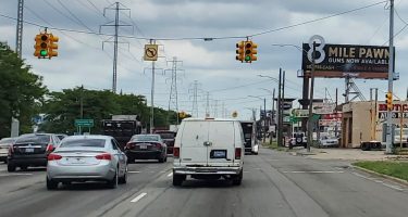 vehicles drive down 8 Mile Road in Detroit, USA