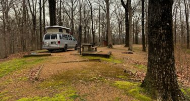 a sportsmobile van parked at a lush campground in Arkansas